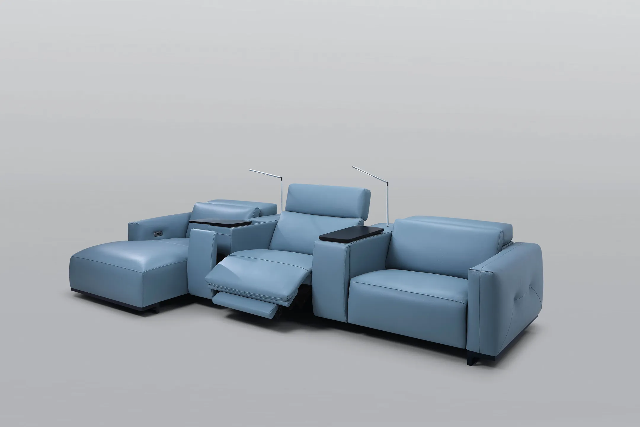 A picture of a blue leather sectional sofa on a grey background